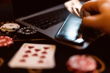 6777BET Slots — Thousands of thrilling machines await A woman smiling by bright slot machines showing lucky symbols, showcasing the exciting slot offerings at 6777BET.