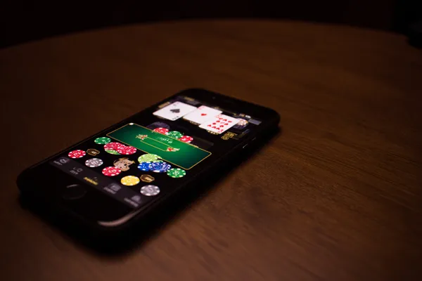 A confident dealer surrounded by casino chips inviting players to access their 6777BET account, reflecting quick and easy login options.